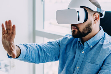 Man in futuristic VR goggles using invisible interface