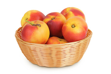 Ripe nectarine fruit in a wicker basket isolated on white background with full depth of field