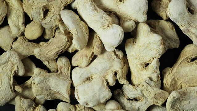 Dried ginger root, close-up. Root of plant Zingiber officinale. Ginger often used in cooking and alternative medicine. 4K video, Rotation.