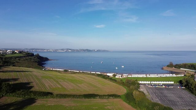 Aerial View of Broad Sands Beach with Colorful Beach Huts on a Sunny Day in Paignton, Devon - 4K Drone Video