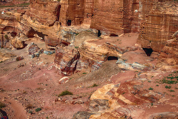 View of the Temples and caves carved into the sandstone rock in the gorge. Petra, Jordan