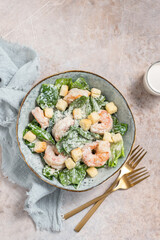 Fresh caesar salad on bowl with parmesan cheese and shrimps