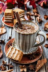 Pumpkin spice latte in mug  on wooden table, selective focus