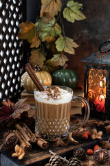 Still life with  pumpkin spice latte  cup on wooden background