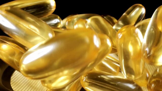 Omega 3 close up. Gold fish oil capsules. Bounce. Golden capsules. Pills Vitamins.