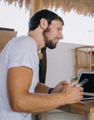 Female assistant showing opened notebook to bearded colleague