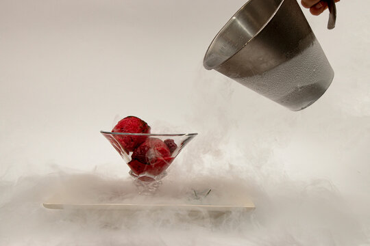 ice cream in a cup, in a white plate in a fog of liquid nitrogen six
