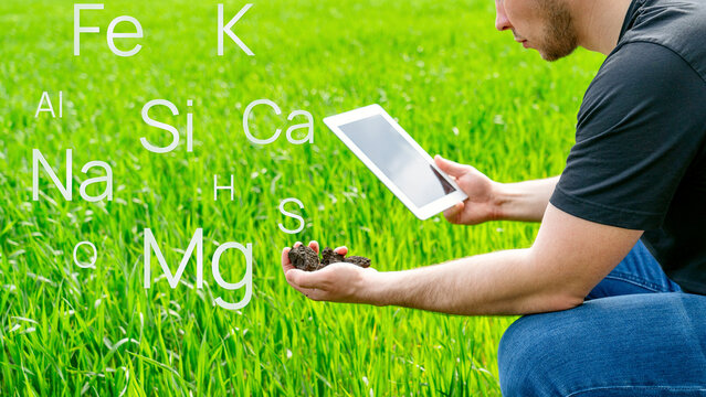 Farmer in field looking at result of soil analysis. Against background of formula of mineral doornail, which must be applied to soil to obtain large yield