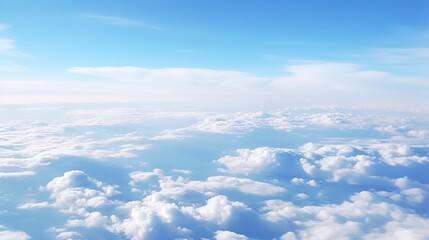 Fototapeta premium Panoramic view of fields and clouds from an airplane window. The sky is a bright blue with fluffy white clouds.