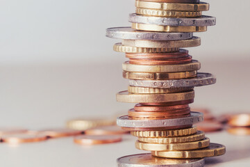 Euro coins stacked in a pile with a blurred background