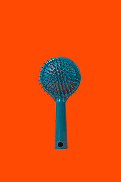 Hair brush on orange surface