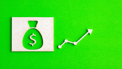 Money bag with arrow up on green background - Concept of increasing banking interest