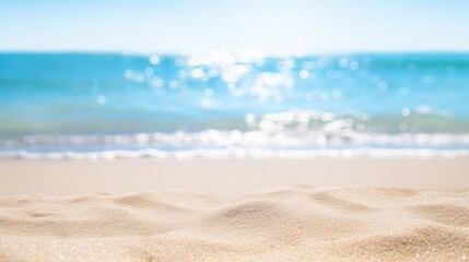 Fototapeta na wymiar Seascape abstract beach background blur bokeh light of calm sea and sky Focus on sand foreground 