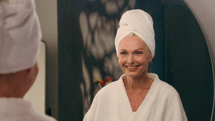 Feminine beauty mature 50s beautiful Caucasian woman in bathrobe old senior middle-aged wrinkled...