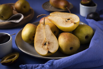 juicy pear with plum on the kitchen table