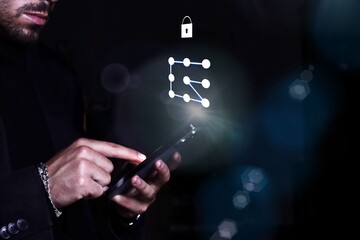 Businessman with smartphone unlocking security pattern lock and access password for cybersecurity...