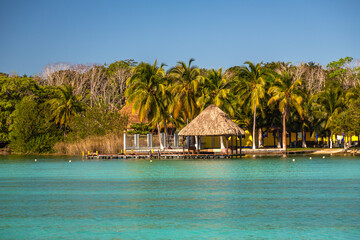 Laguna de Bacalar is also known as the Lagoon of Seven Colors, in Bacalar, Mexico. The crystal clear waters and white sandy bottom of the lake cause the water color to morph into varying shades of tur