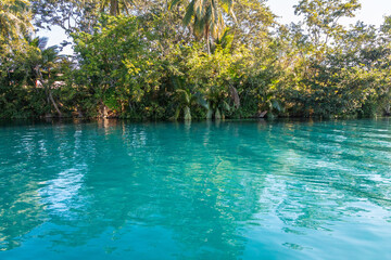 Laguna de Bacalar is also known as the Lagoon of Seven Colors, in Bacalar, Mexico. The crystal clear waters and white sandy bottom of the lake cause the water color to morph into varying shades of tur