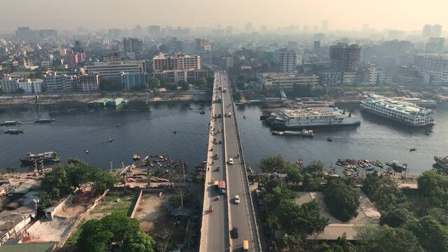 Aerial view of Dhaka city, the vibrant and bustling capital of Bangladesh. The cosmopolitan city is a blend of modern and traditional, with towering skyscrapers, bustling markets. Buriganga