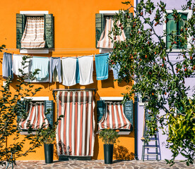  colorful house facade with clothing drying in Burano Venice
