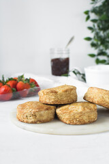 Homemade scones on a white marble tray, freshly baked yogurt scones, buttermilk scones on a white background