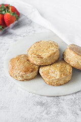 Homemade scones on a white marble tray, freshly baked yogurt scones, buttermilk scones on a white background