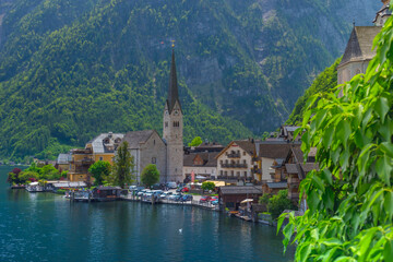 Fototapeta na wymiar Hallstatt, a charming village on the Hallstattersee lake and a famous tourist attraction, with beautiful mountains surrounding it, in Salzkammergut region, Austria, in summer sunny day.