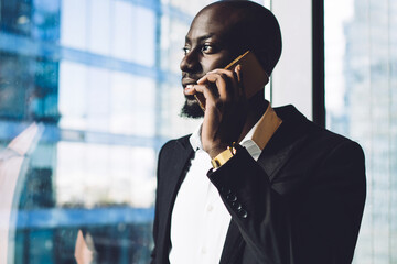 Successful African American businessman talking on smartphone in office