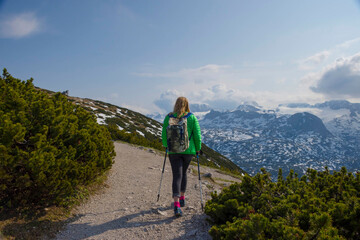 Tourist woman trekking on Mount Krippenstein in the Dachstein Mountains of Upper Austria, Salzkammergut region, Austria.