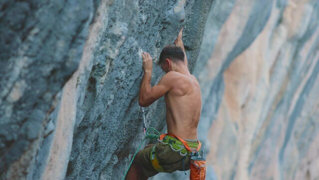 rock climber Strong male climber overcomes a difficult route. sport climbing. climber on the route. Sport and health.