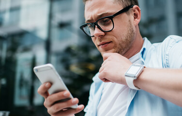 Young man using phone on street