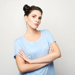 lifestyle, emotion and young people concept: young woman dressed casual posing with crossed arms