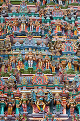 Fototapeta na wymiar Sculptures on Hindu temple gopura (tower). Menakshi Temple, Madurai, Tamil Nadu, India