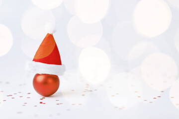 Fototapeta premium Christmas ball with Christmas hat on white background