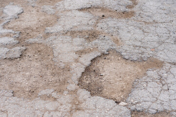 Pits on the road and destroyed asphalt. Background with copy space