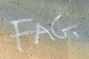 derogative term on a concrete wall