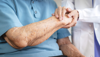 Parkinson disease patient, Alzheimer elderly senior, Arthritis person's hand in support of geriatric doctor or nursing caregiver, for disability awareness day, ageing society care service - obrazy, fototapety, plakaty