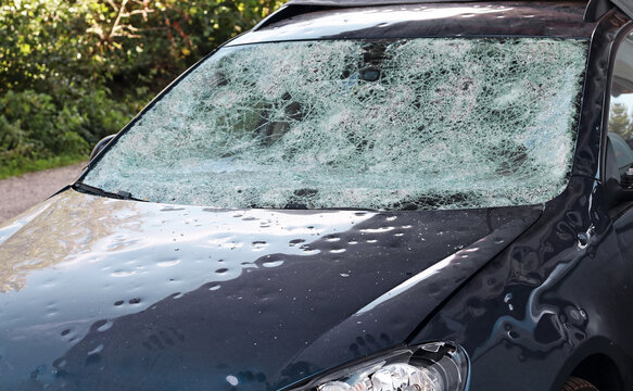 Hagelschaden an einem Auto. Gro&szlig;e Hagelk&ouml;rner haben ein Auto v&ouml;llig zerst&ouml;rt