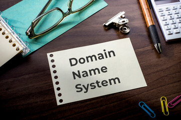 There is notebook with the word Domain Name System. It is as an eye-catching image.