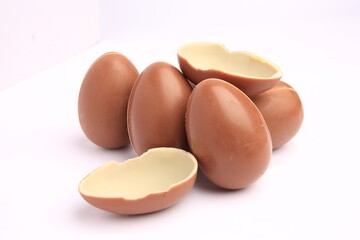Sveti Vlas, Bulgaria - June 27, 2023: Unwrapped Kinder Surprise Eggs isolated on white