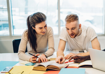 Cheerful multiethnic entrepreneurs working together in office
