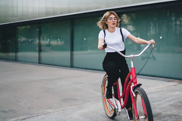 Fototapeta na wymiar Student female cycling on street