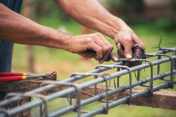 Men hands using pincer pliers iron wire reinforcement of concrete work. Construction Worker hands...