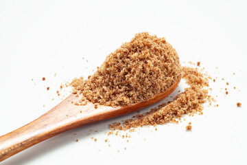 Brown sugar powder with wooden spoon on white background