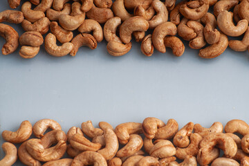 a bunch of cashews spread out on an isolated white table