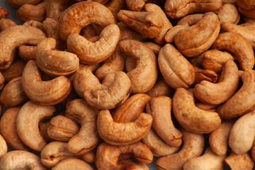 a bunch of cashews spread out on an isolated white table