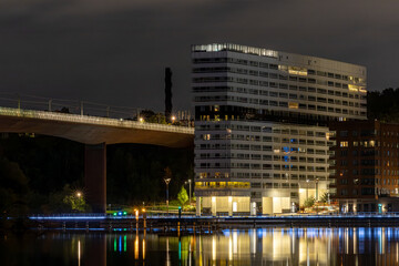 Fototapeta premium Stockholm, Sweden The Liljeholmskajen district at night and reflections in the Arstaviken.