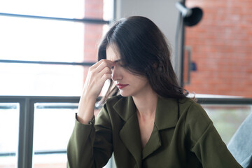 Fototapeta premium asian business woman headache at office