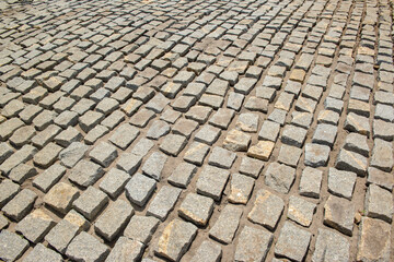 Cobblestones forming a background. Paving stones used in the streets of Brazil.