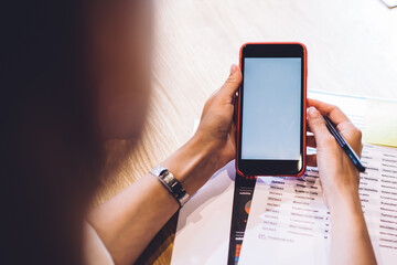 Woman browsing mobile phone in office